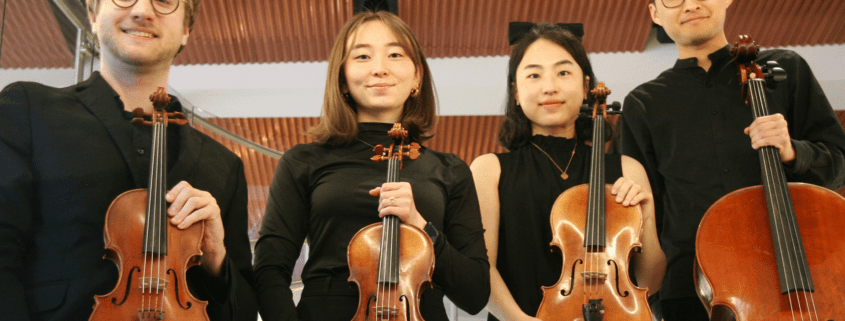 A photo of the Rabin String Quartet holding instruments.