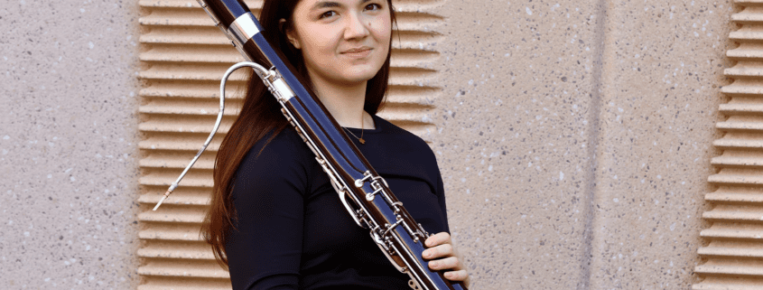 A photo of Katrina Feltz holding a bassoon.