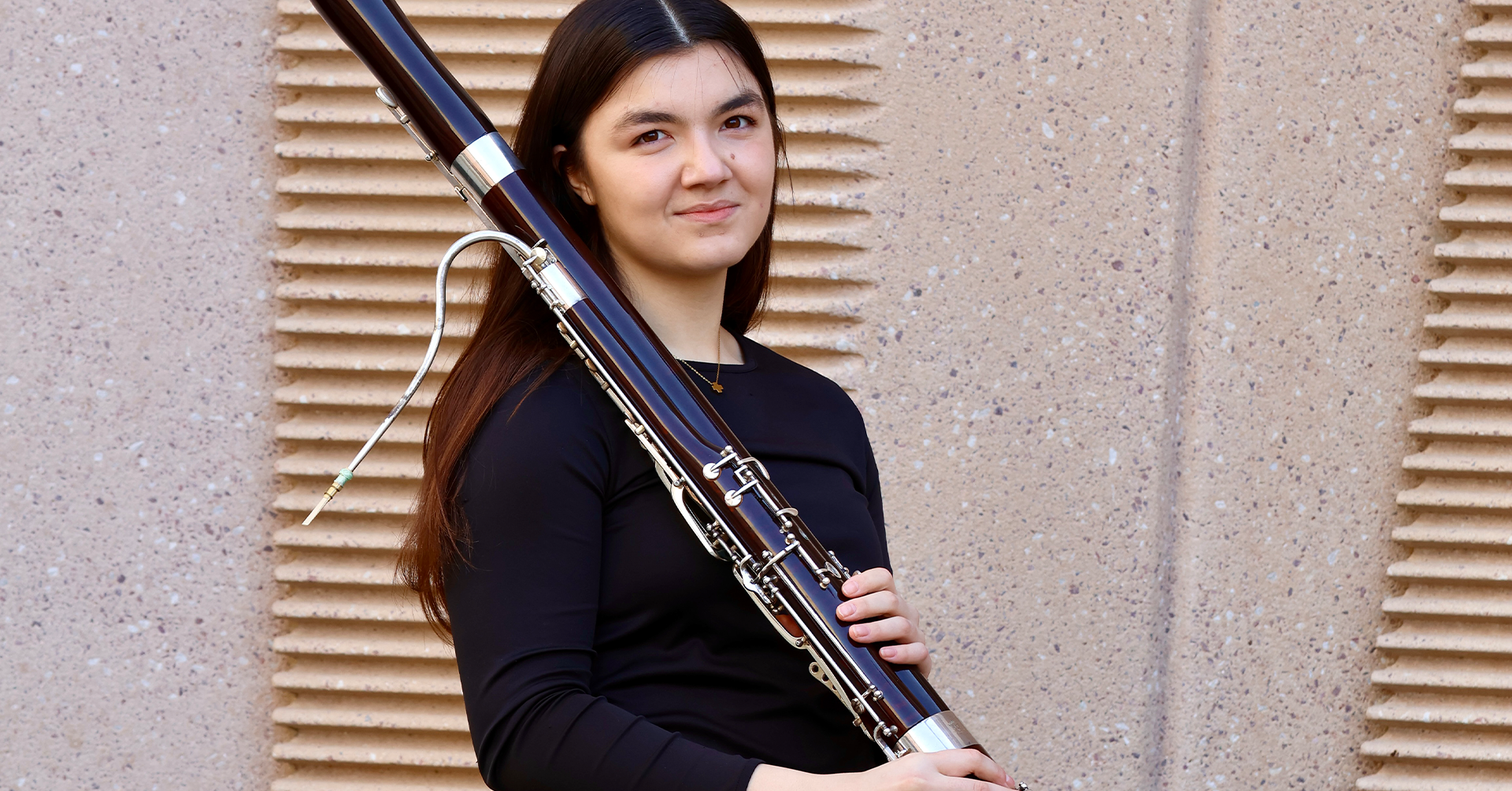 A photo of Katrina Feltz holding a bassoon.