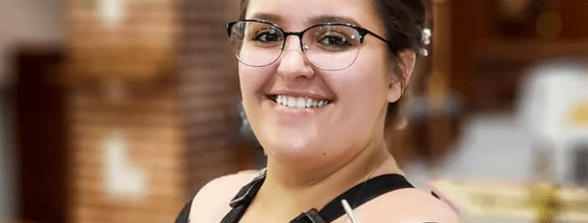 A photo of Meghan Boelkow holding a bassoon.