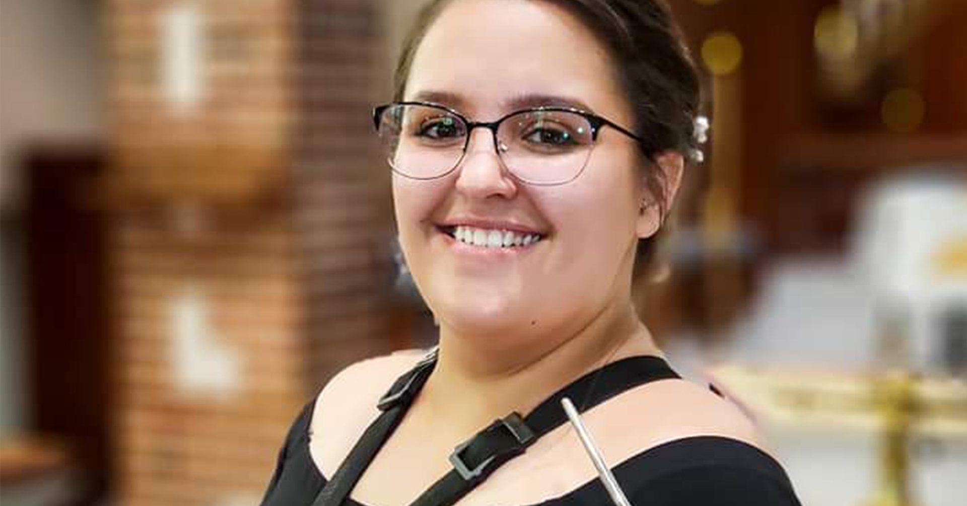 A photo of Meghan Boelkow holding a bassoon.