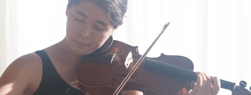 A photo of Sage Eckard-Lee playing violin.