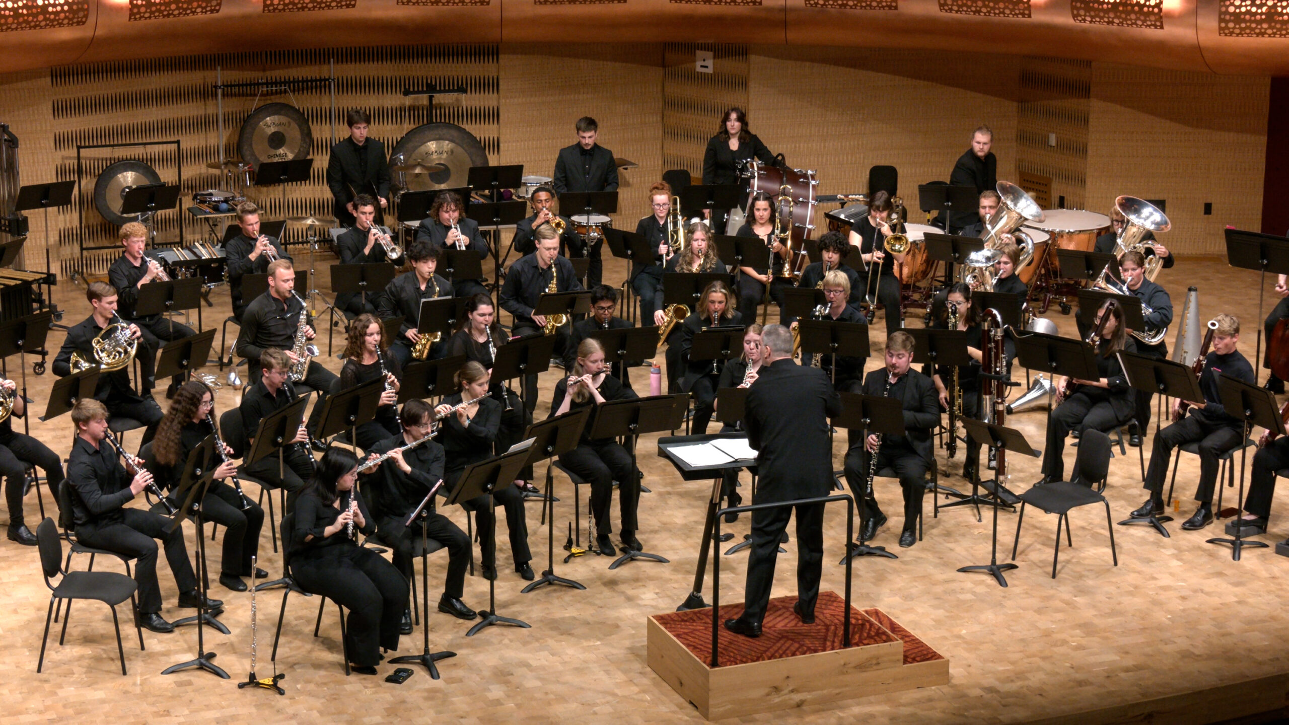 A photo of Wind Ensemble performing on stage at the Hamel Music Center.