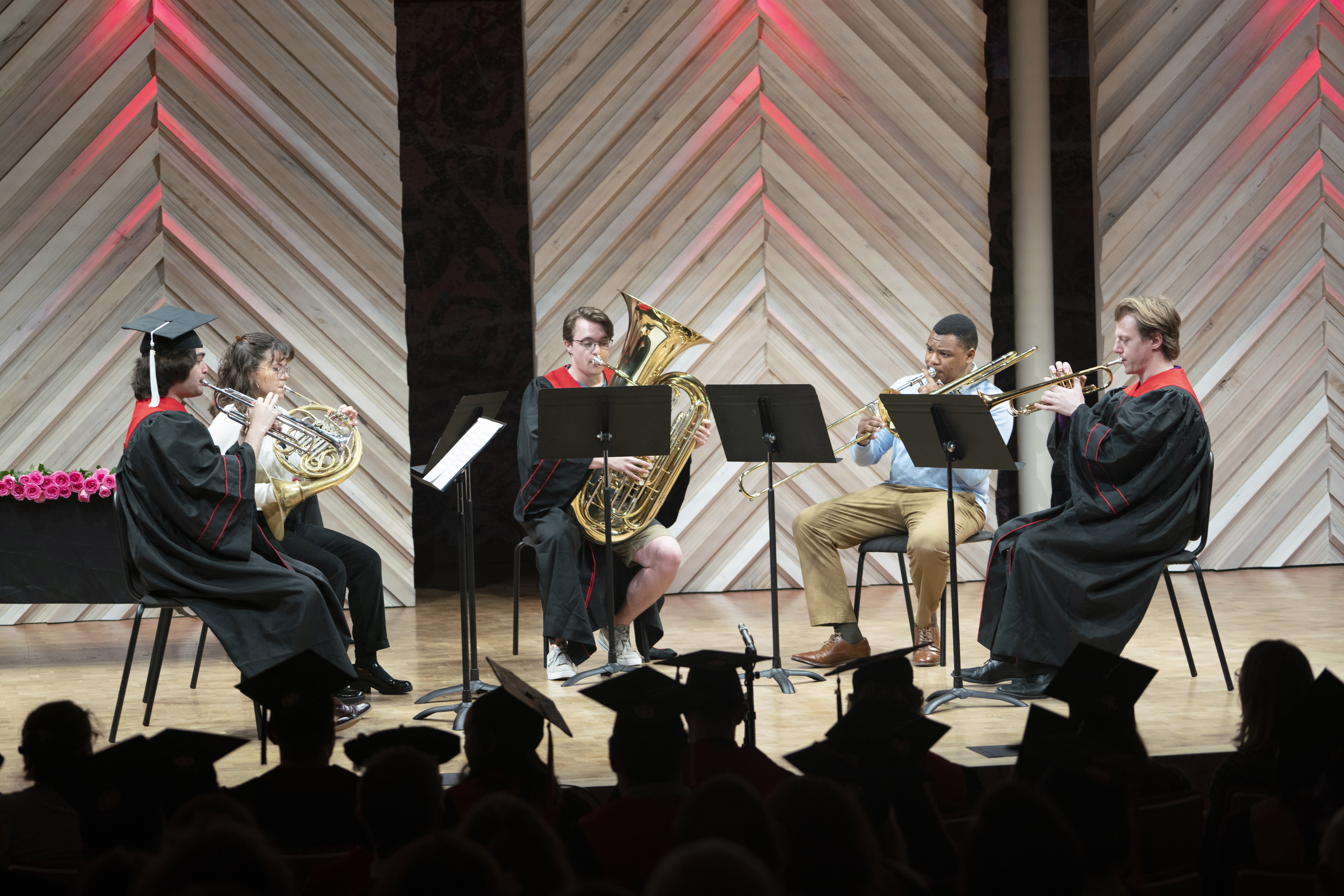 A photo of a student brass quartet performing on stage in Collins Recital Hall at the Hamel Music Center.