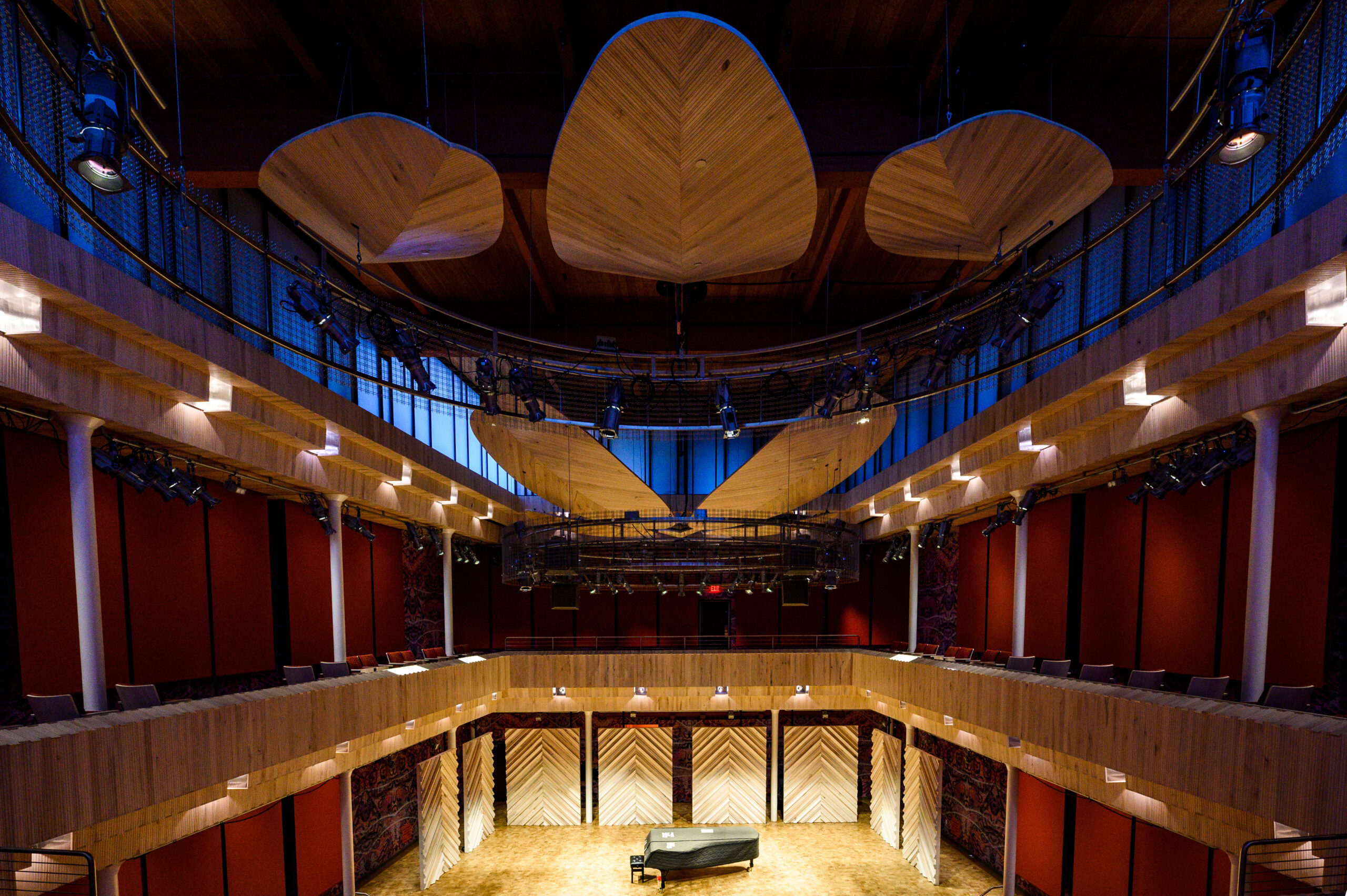 A photo of Collins Recital Hall with a piano on stage.
