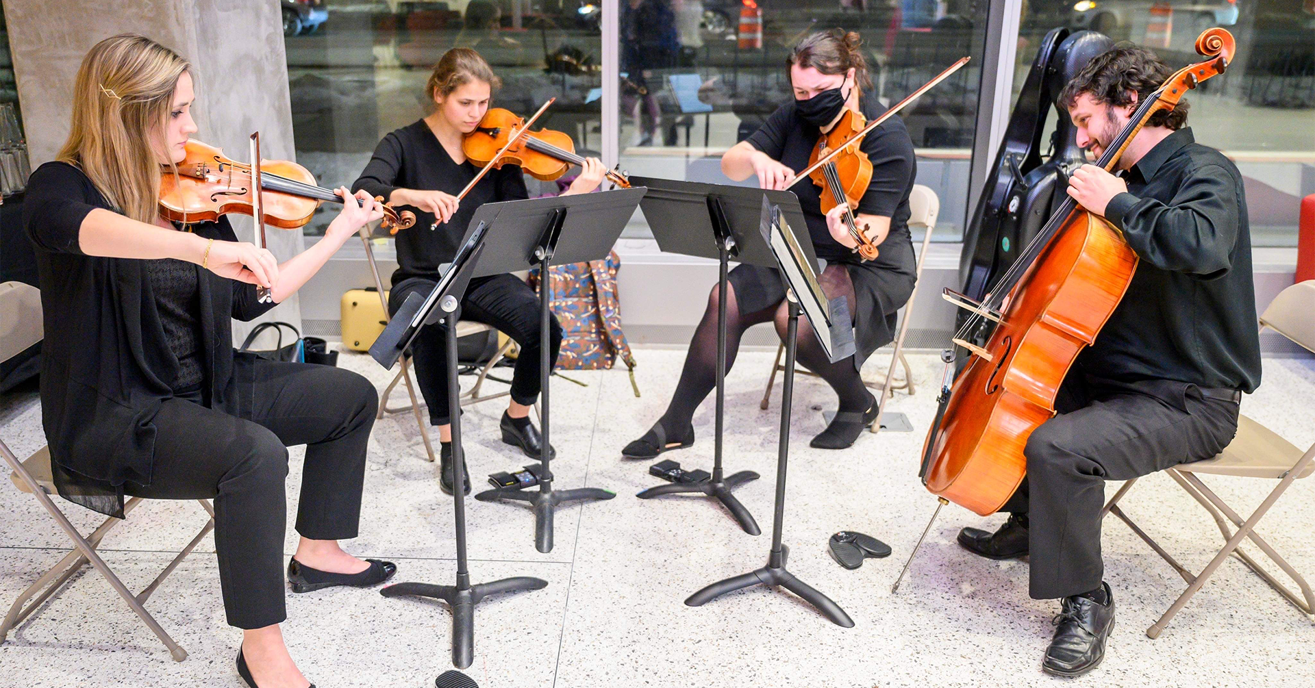 A photo of the Rabin String Quartet performing.