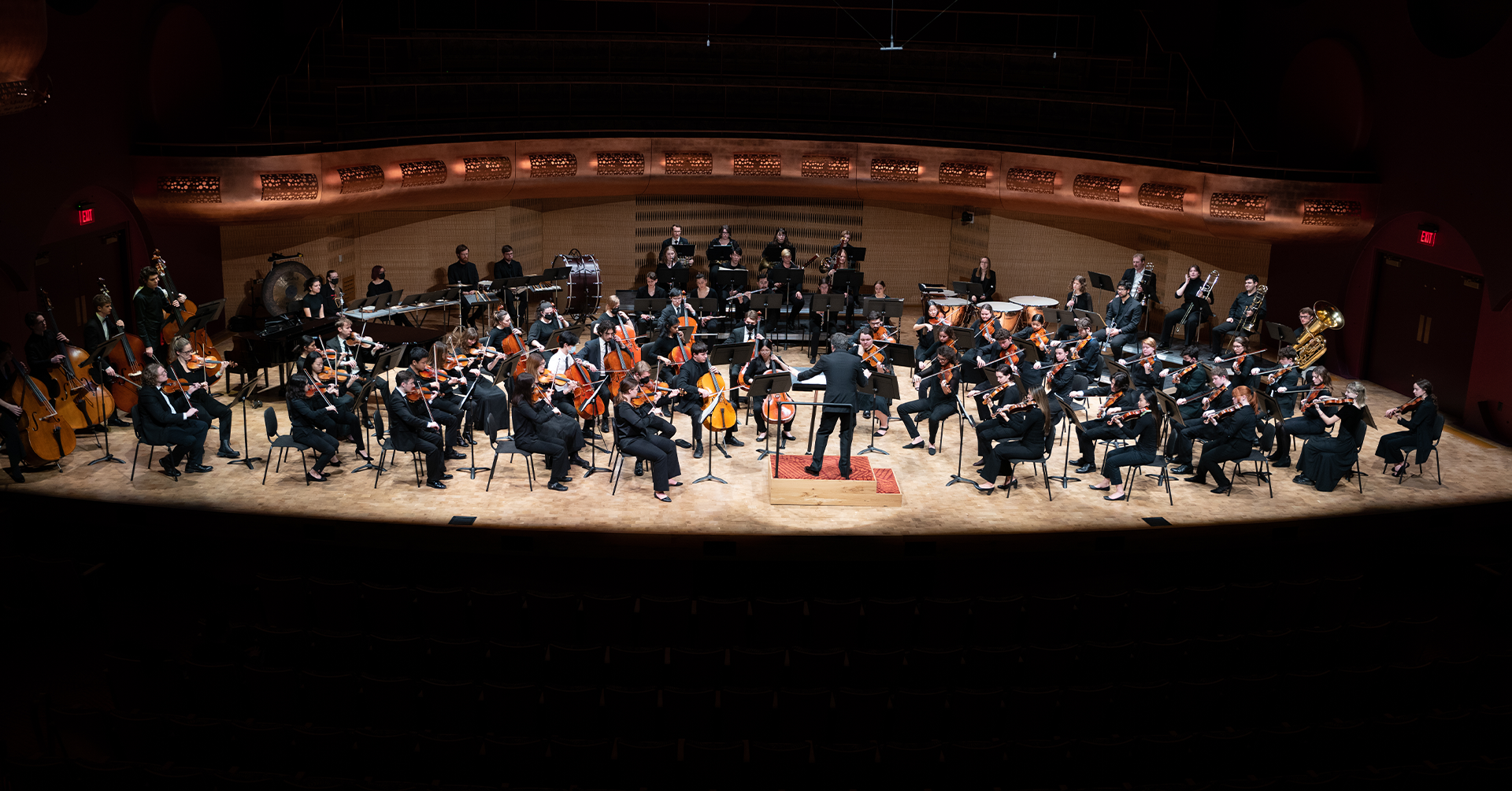 A photo of University Symphony Orchestra performing on stage at the Hamel Music Center.