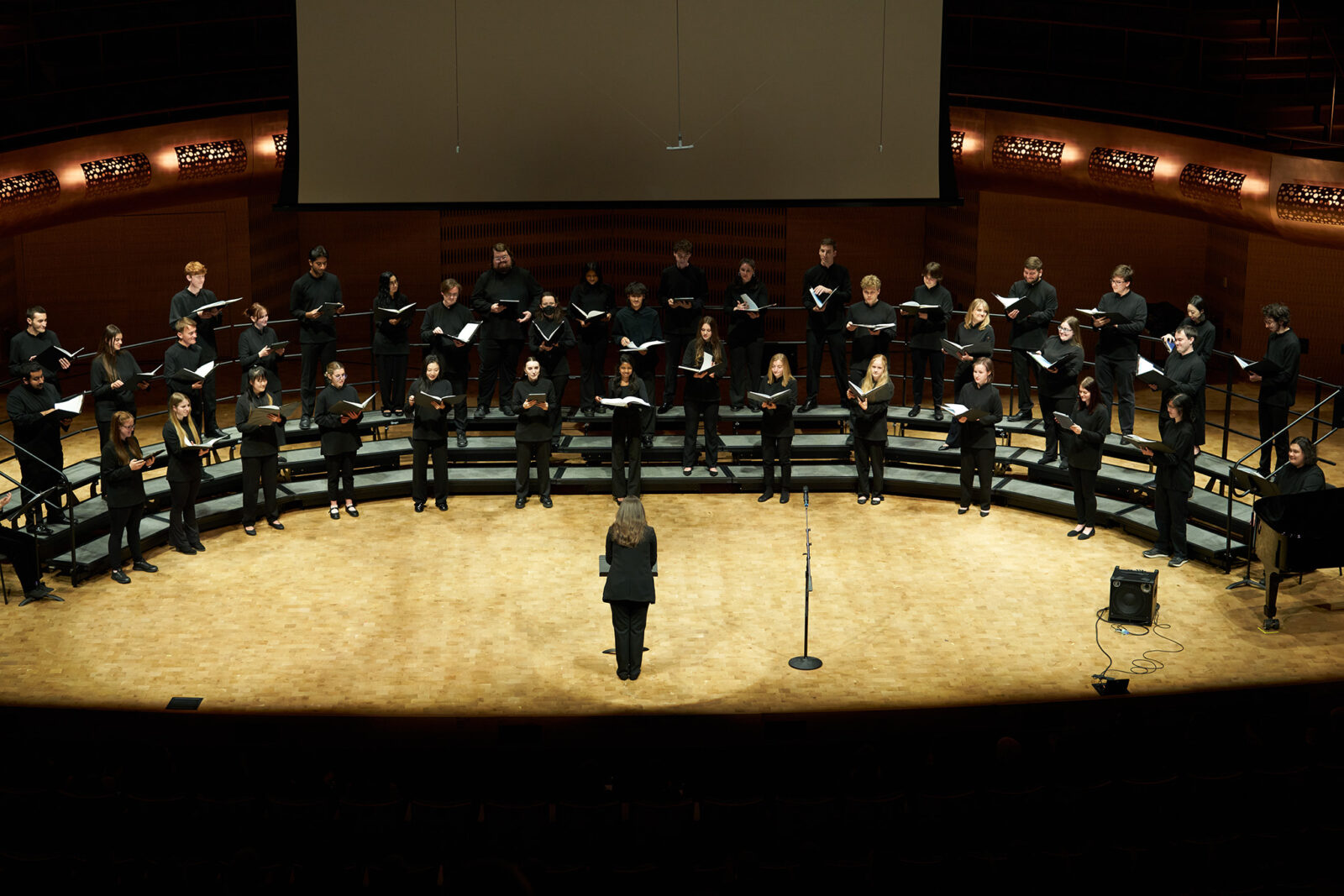 A photo of University Chorus performing on stage at the Hamel Music Center.
