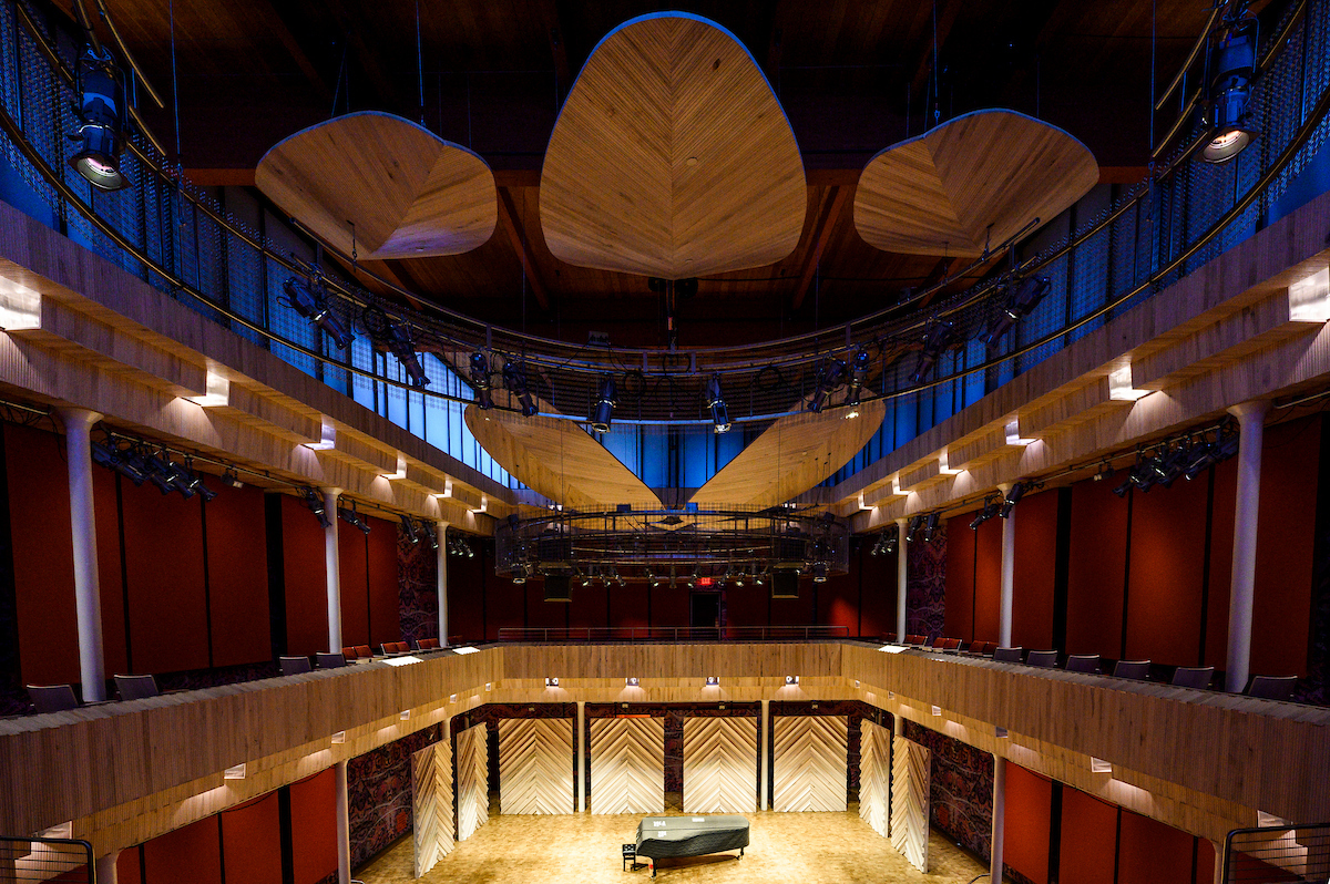 A photo of Collins Recital Hall with a piano on stage.