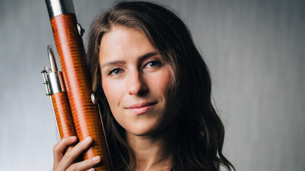 A photo of Eleni Katz holding a bassoon.