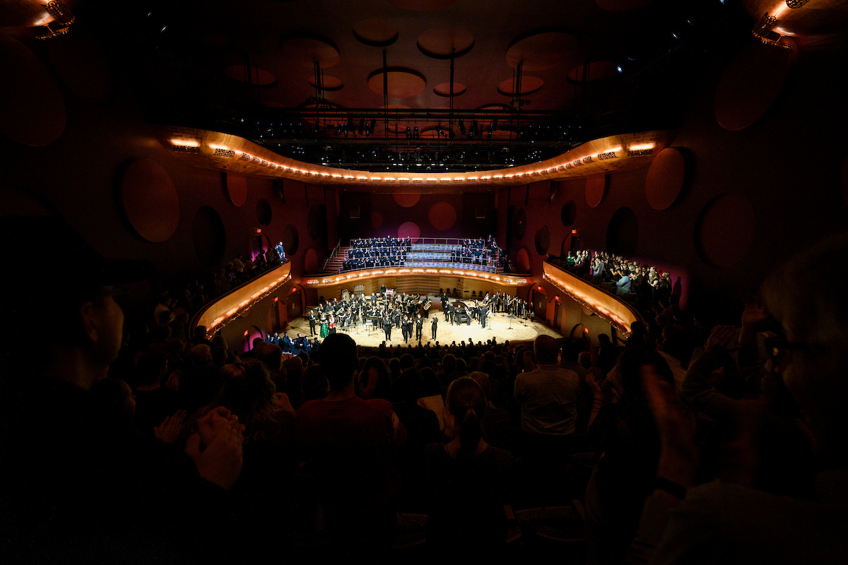 A photo of a crowd applauding for performers on stage at the Mead Witter Foundation Concert Hall at the Hamel Music Center.