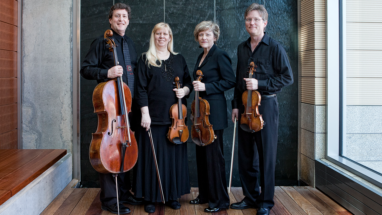 A photo of Pro Arte Quartet with instruments.