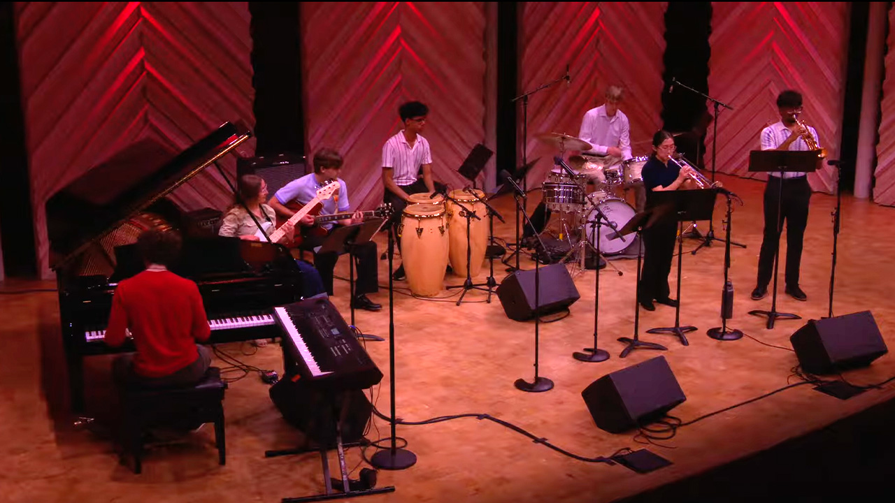 A photo of Resistance Music Ensemble performing on stage in Collins Recital Hall at the Hamel Music Center.