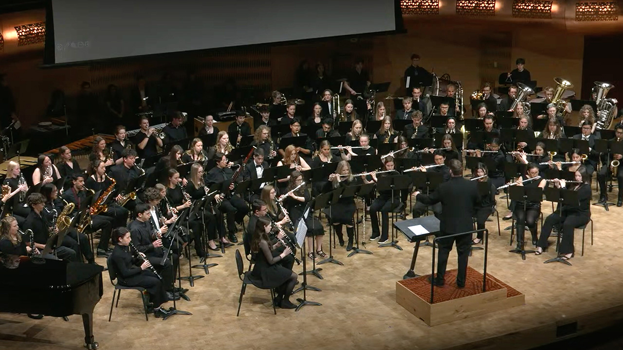 A photo of University Bands performing on stage at the Hamel Music Center.