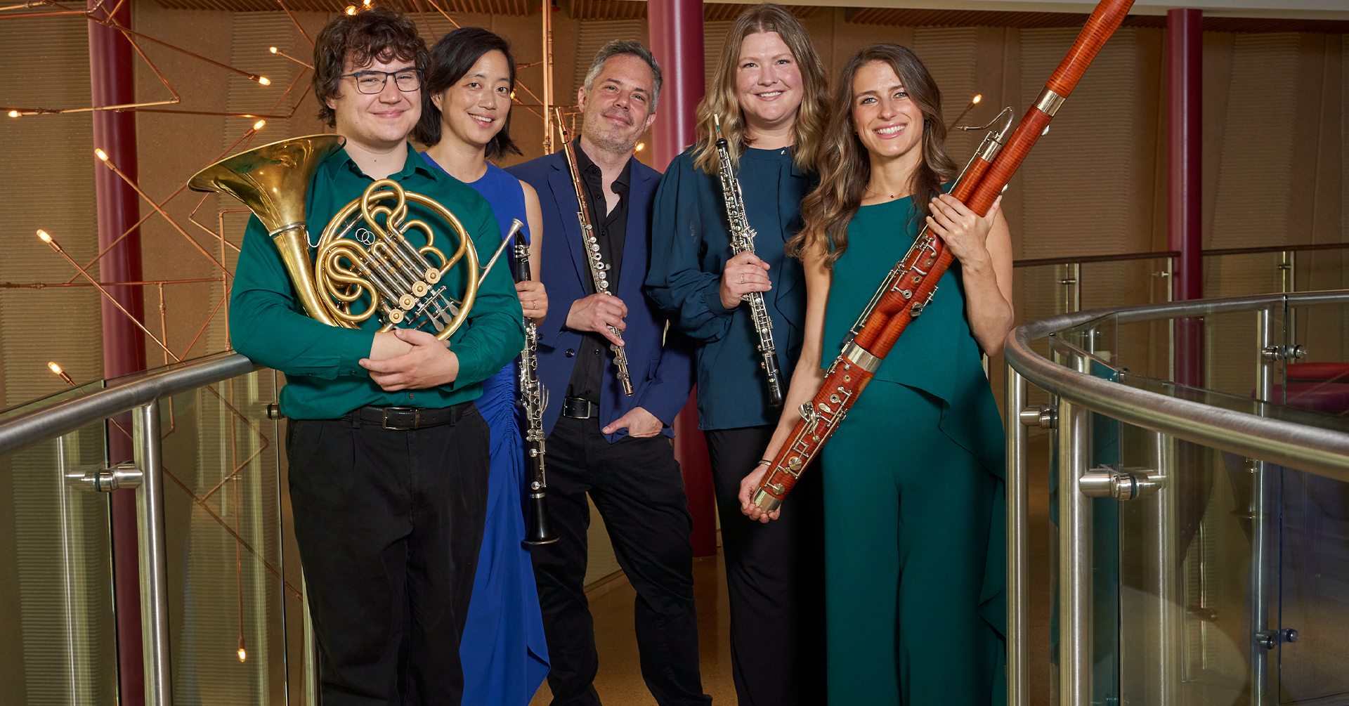A photo of Wingra Wind Quintet holding instruments.