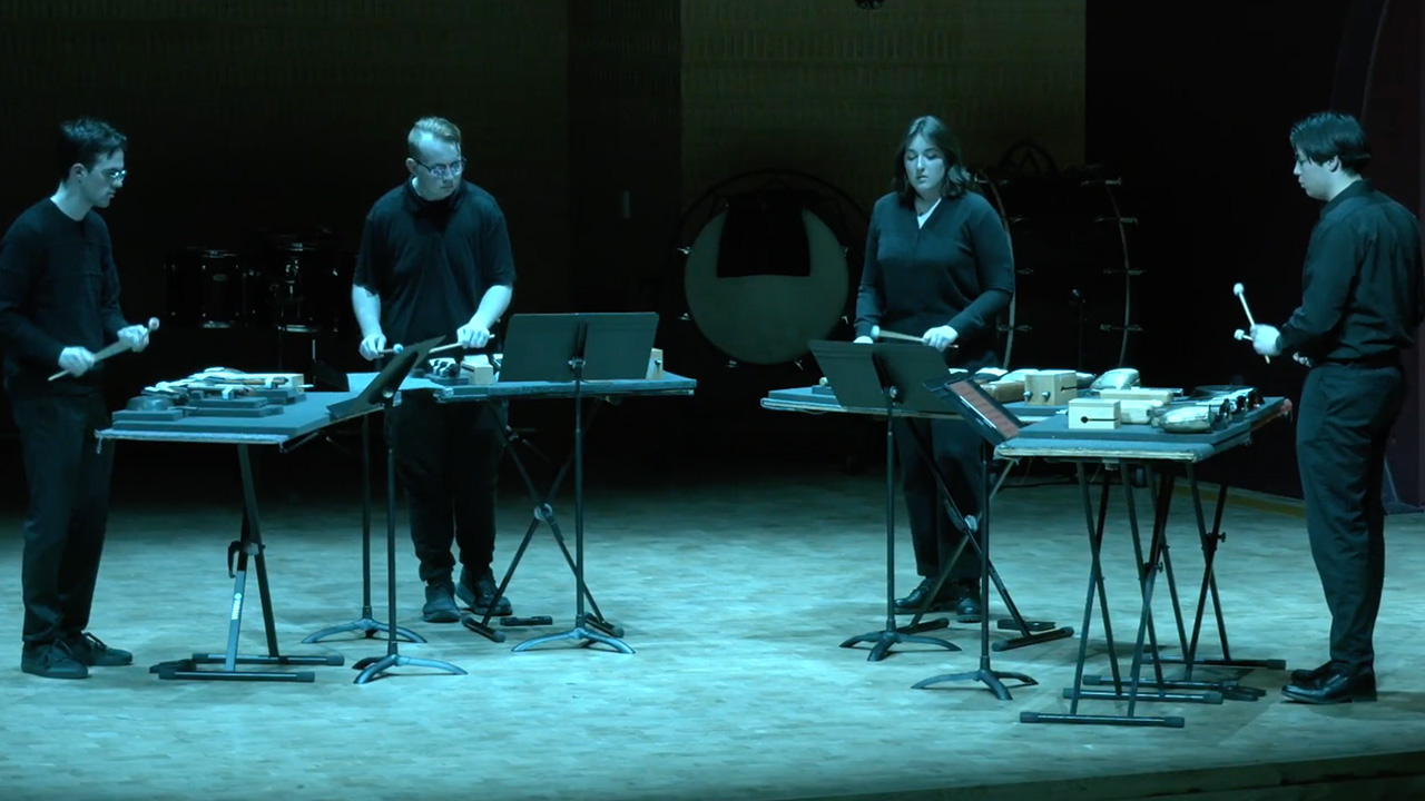 A photo of the Chamber Percussion Ensemble performing on stage in the Mead Witter Foundation Concert Hall at the Hamel Music Center.
